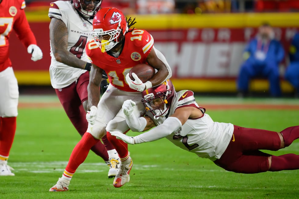 Washington Commanders cornerback Marshon Lattimore (2) tries to tackle Kansas City Chiefs...
