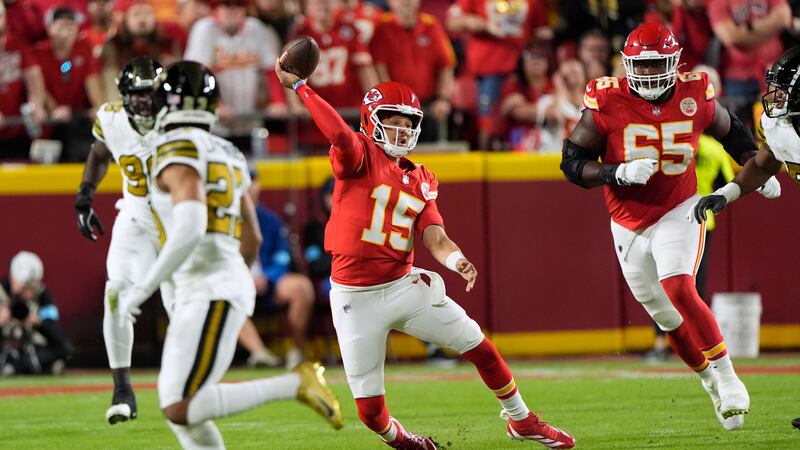 Kansas City Chiefs quarterback Patrick Mahomes falls as he throws during the first half of an...