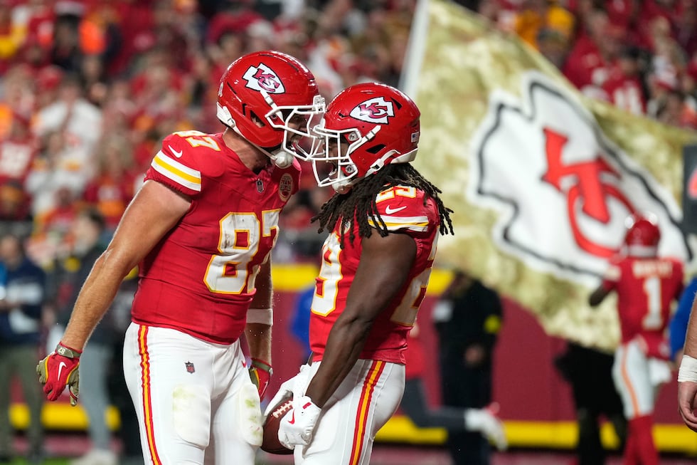 Kansas City Chiefs running back Kareem Hunt, right, is congratulated by teammate Travis Kelce...