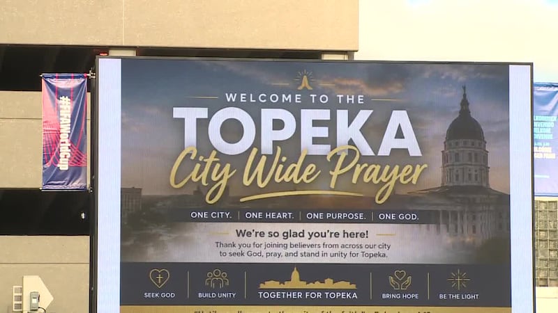People gather at Evergy Plaza for the Topeka City Wide Prayer event.